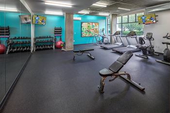 a fitness room with treadmills and other exercise equipment at The Parker Apartments, Oregon